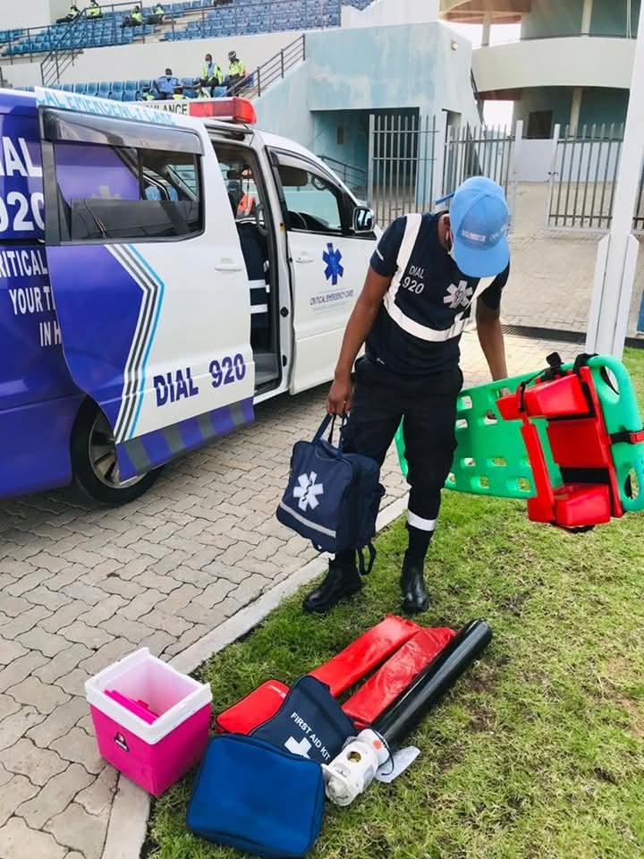 A medic with a spine board and equipment